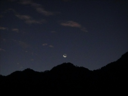 NEW MOON SETTING OVER THE MOUNTAIN